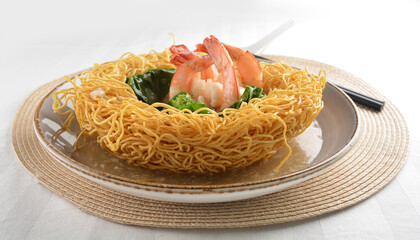 deep fried crispy yellow noodle mee with seafood big prawn and vegetable in thick gravy sauce asian...
