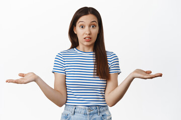 Sorry I didnt know. Clueless 20s woman shrugging shoulders, spread empty hands sideways and look...