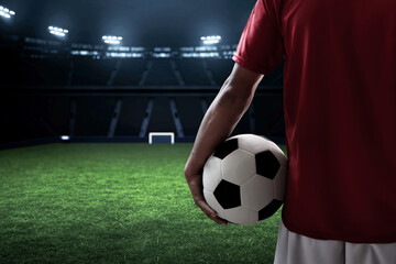 Soccer player holding a ball