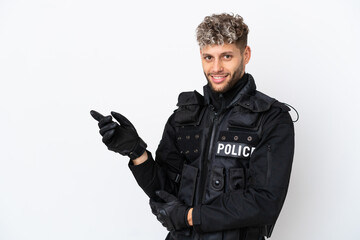 SWAT caucasian man isolated on white background pointing finger to the side