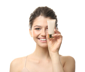 Beautiful girl with tube of foundation on white background