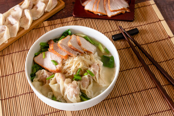 Wonton food with dumpling and roasted pork in bowl as local Chinese food