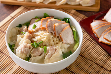 Wonton food with dumpling and roasted pork in bowl as local Chinese food