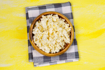 two bowls of popcorn on a yellow background.