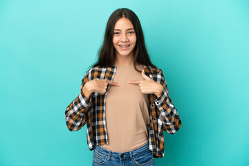 Young French woman isolated on blue background with surprise facial expression