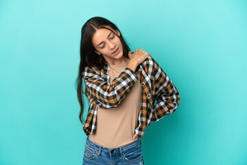 Young French woman isolated on blue background suffering from pain in shoulder for having made an effort