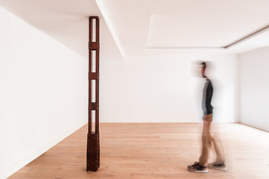 Man standing in gallery with creative art object