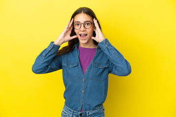 Young French woman isolated on yellow background with surprise expression