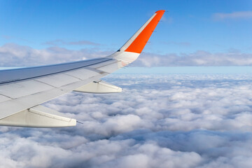 Fototapeta na wymiar Wing airplane by airplane window frame, concept travel and freedom.