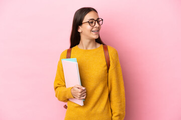 Young student woman over isolated background looking side