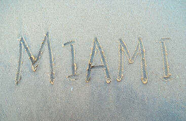 Miami word is written on a beach sand. Miami city inscription on a sand. USA