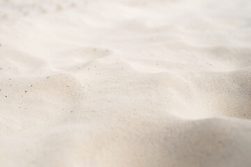 Fototapeta na wymiar The texture of white sand in perspective.