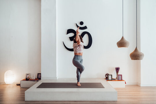 Graceful woman practicing yoga in Eagle pose