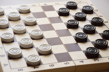 checkers. a board game for brains, strategy. black and white figures.