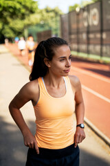 Young sporty woman training in the park. Beautiful woman in sportswear working out.