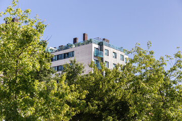 Fototapeta na wymiar Modern apartment building with beautiful roof terrace. Copy space
