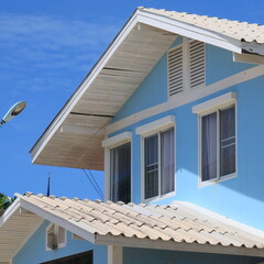 Double gable blue beach house against blue sky