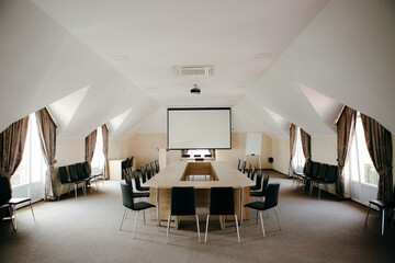 A long table in a light spacious conference room