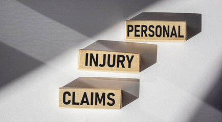 Personal injury claims text from wooden blocks on desk