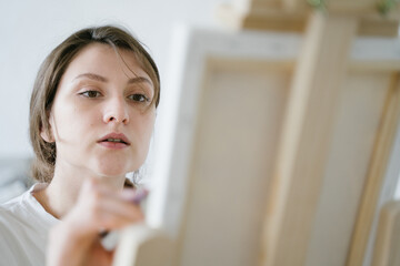 The focused face of the artist. Creative process. Talented entrepreneur draws pictures to order