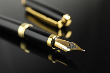 Beautiful fountain pen with ornate nib on black background, closeup