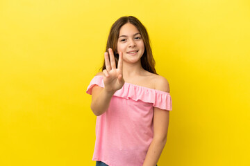 Little caucasian girl isolated on yellow background happy and counting three with fingers