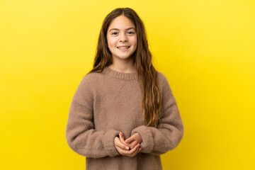 Fototapeta premium Little caucasian girl isolated on yellow background laughing