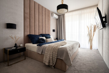 Elegant and comfortable bedroom with big window