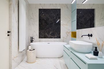 Naklejka na ściany i meble Elegant bathroom with marble tiles and blue furniture