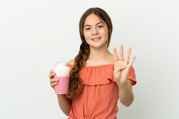 Little caucasian girl with strawberry milkshake isolated on white background happy and counting four with fingers