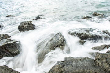 Slow shutter speed, water hitting rocks.