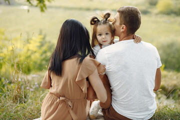 Cute family playing in a autumn field