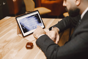 Stylish businessman sitting at the table