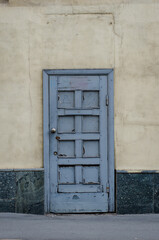 A grey old door with the cracked paint In Kharkiv, Ukraine