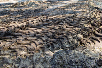 
traces of tractor wheels in the mud