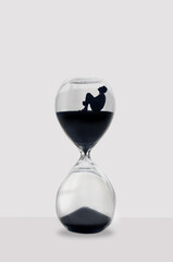 Illustration: Man sitting inside an hourglass wait for time to pass. Ideal concept for depression,...