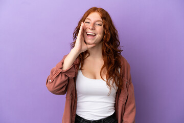 Teenager redhead girl over isolated purple background shouting with mouth wide open