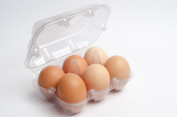 Fototapeta na wymiar A bundle of 6 free-range eggs on a white background