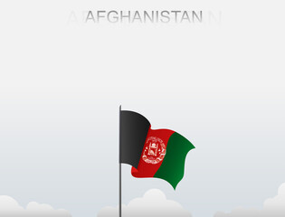 Afghanistan flag flying on a pole standing tall under a white sky