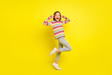 Fototapeta na wymiar Full body photo of funky short hairdo small girl show v-sign wear shirt trousers isolated on yellow color background