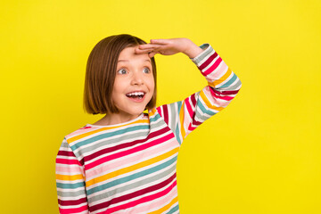 Photo of cool short hairdo small girl hand head look empty space wear colorful shirt isolated on vivid yellow color background