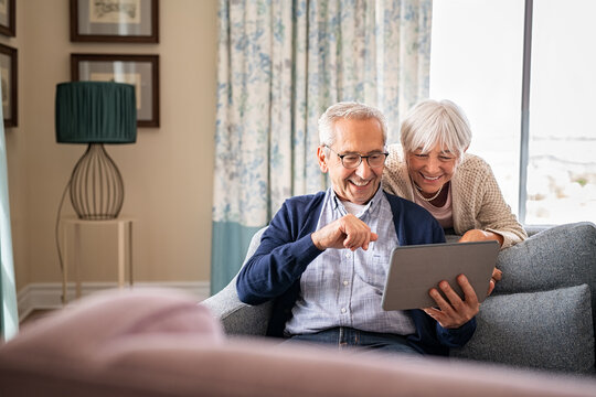 Senior couple using digital tablet for a video call with family