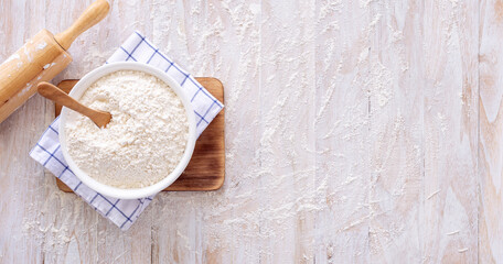 Homemade dough recipe (eggs, flour, milk, sugar) on a wooden table top view.