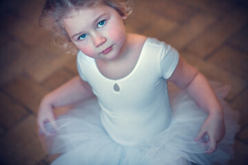 Funny little ballerina in tutu. Image with selective focus, toning and noise effect.