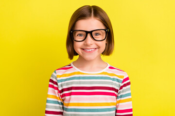 Photo of happy nice positive small girl smile good mood wear sunglass isolated on shine yellow color background