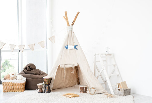 Kids room interior with wigwam, toys and djembe drums