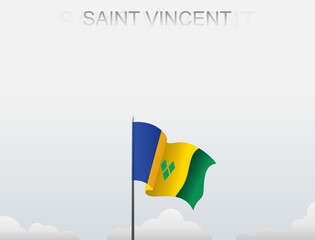 Saint Vincent flag flutters on a pole standing tall under a white sky