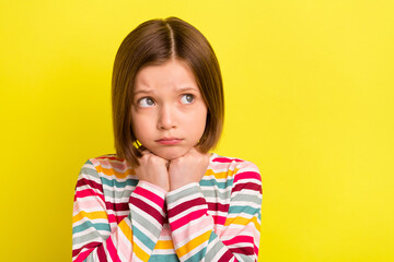 Photo of unhappy sad young little girl look empty space bad mood negative isolated on yellow color...