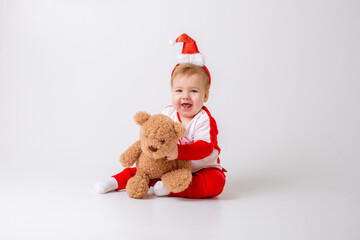 baby boy in santa hat with gifts on white background