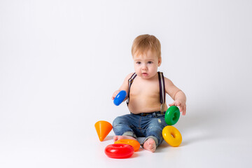 Fototapeta na wymiar toddler baby boy with toy on white background